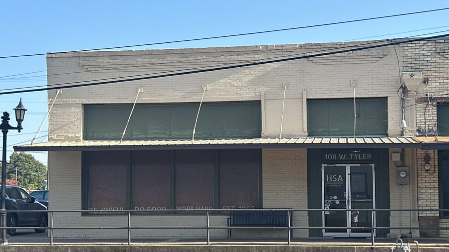 Hearn Surveying Associates' office storefront on West Tyler Street in Athens, Texas, with Be Joyful, Do Good, Work Hard painted on the window